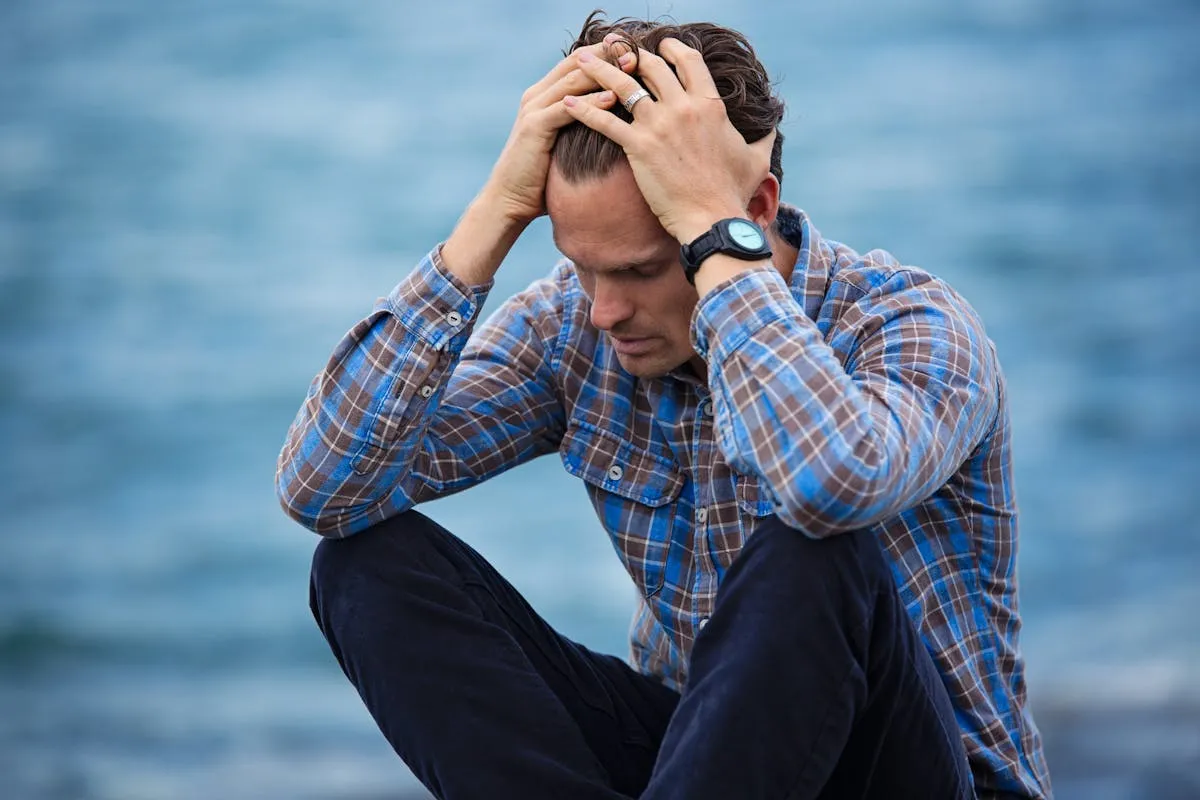 Stressed business owner with head in hands